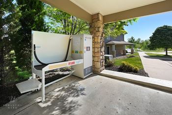 an air conditioning unit sits on a patio in front of a house
